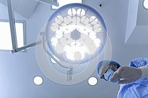 Surgeon standing above of the patient before surgery. healthcare worker performing surgery on patient at operation theater