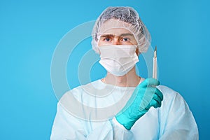 Surgeon in sterile blue uniform, medical gloves and mask