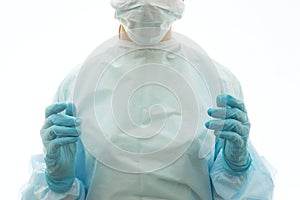 Surgeon in sterile gown, surgical mask and gloves is ready to work