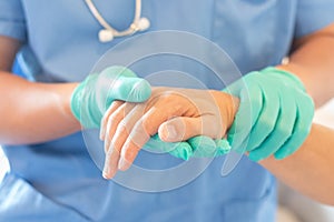 Surgeon, surgical doctor, anesthetist or anesthesiologist holding patient`s hand for health care trust and support in professional
