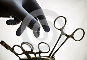 Surgeon take scissors of suture to operate in operating room, co