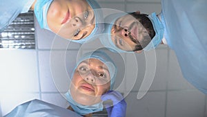 Surgeon team wearing masks, ready for operation, patient pov in consciousness