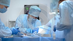 Surgeon team working in operation room, performing cardiothoracic surgery photo