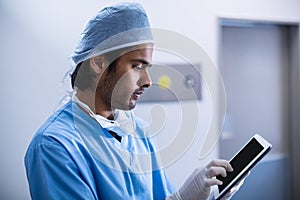 Surgeon using digital tablet in operation room