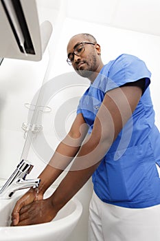 Surgeon washing hands before operating photo