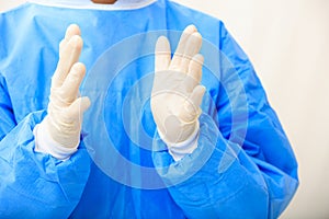 Surgeon wearing latex gloves