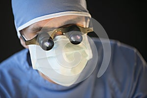 Surgeon Wearing Mask And Magnifying Glasses