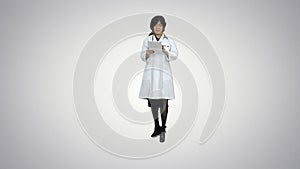Surgeon woman doctor smile using tablet pc and talking to a camera on white background