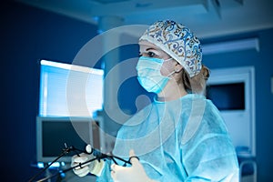 Surgeon woman doing laparoscopic operation photo