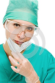 Surgeon woman in protective glasses and mask