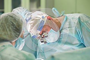 Surgeon working on a patient during medical procedure in hospital operating room