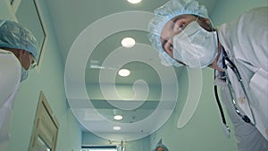 Surgeons looking down at patient getting ready for urgent surgery