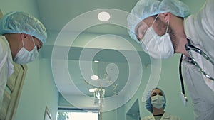 Surgeons looking down at patient getting ready for urgent surgery