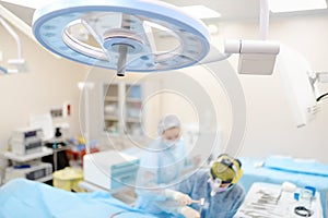 Surgeons are during maxillofacial operation using microscope and endoscope in modern hospital. Teamwork of doctors. Maxillofacial photo