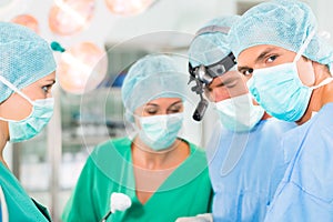 Surgeons operating in operation theater room