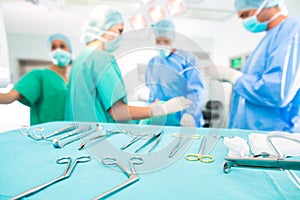 Surgeons operating patient in operating room photo