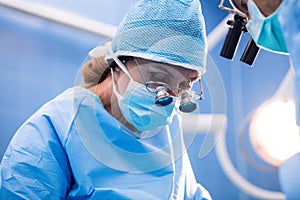 Surgeons performing operation in operation room