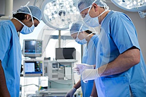 Surgeons performing operation in operation room