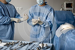 Surgeons prepare sterile medical instruments for surgery