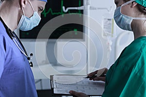 Surgeons reading medical tests