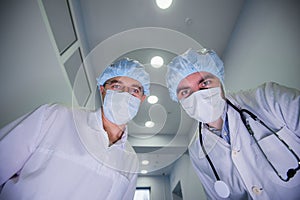 Surgeons standing above of the patient before surgery