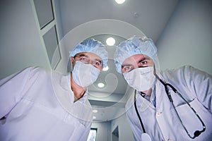 Surgeons standing above of the patient before surgery