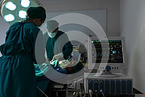 Surgeons team doctor operating and working with Monitoring of patient in surgical operating room