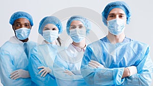 Surgeons Team. Doctors Wearing Protective Uniform, Look At Camera