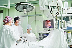 Surgeons team hands during laparoscopic abdominal operation in child surgery