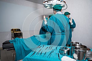 Surgeons team in surgical gown performing surgery a seriously injured patient and surgical equipment in operating room