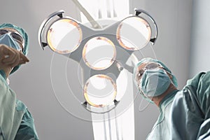 Surgeons Under Surgery Lights In Operating Theatre