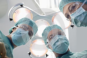 Surgeons Under Surgery Lights In Operating Theatre