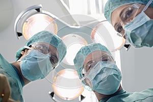 Surgeons Under Surgery Lights In Operating Theatre photo