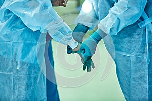 Surgeons wear sterile gloves before surgery
