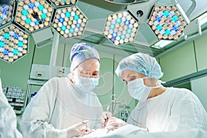 Surgeons at work. female doctors operating in child surgery hospital photo