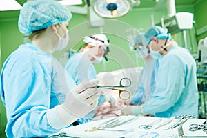 Surgeons at work. female nurse operating in child surgery hospital photo