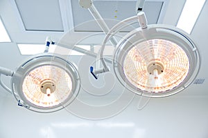 Surgery lamps or lights illuminate the surgery when a team of doctors is performing surgery in a hospital operating room
