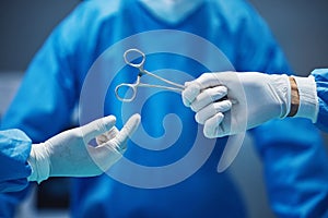 Surgery, nurse hands doctor scissors with medicine and surgical procedure, closeup and healthcare in hospital. Health