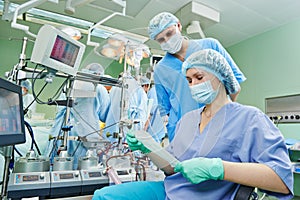 Surgery nurse working during operation