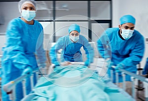 Surgery team, bed and rush in hospital, healthcare or patient emergency. Busy, medical staff or doctors with sick person