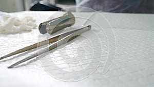 Surgery tools preparation. Close-up shot of nurse in operating room preparing scalpels and medical instruments, devices