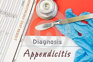 Surgical diagnosis of Appendicitis. Surgical medical instrument scalpel, latex gloves, blood test analysis lie close beside text i
