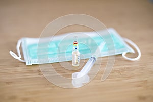 Surgical ear-loop mask and injection syringe