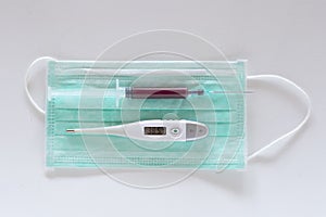 Surgical ear-loop mask, injection syringe and thermometer