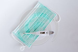 Surgical ear-loop mask and thermometer