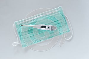 Surgical ear-loop mask and thermometer