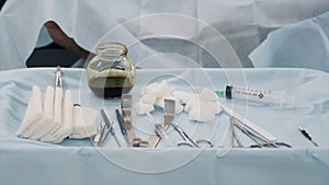 Surgical equipment set for surgery in operation room in the hospital. Action. Close up of medical tools, iodine cup and