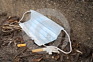 Surgical Face Mask that has been Discarded in the Gutter