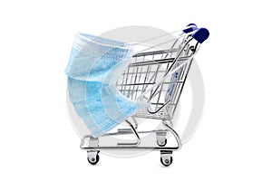 Surgical face mask on little shopping trolley or cart, mandatory masking on supermarkets, coronavirus