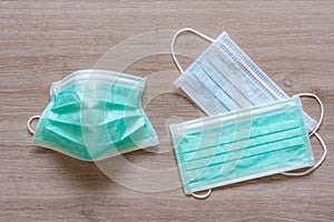 Surgical face masks for preventing covid-19 disease on wooden background